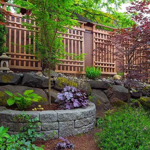 Maintained landscape bed with shrubs and mulch